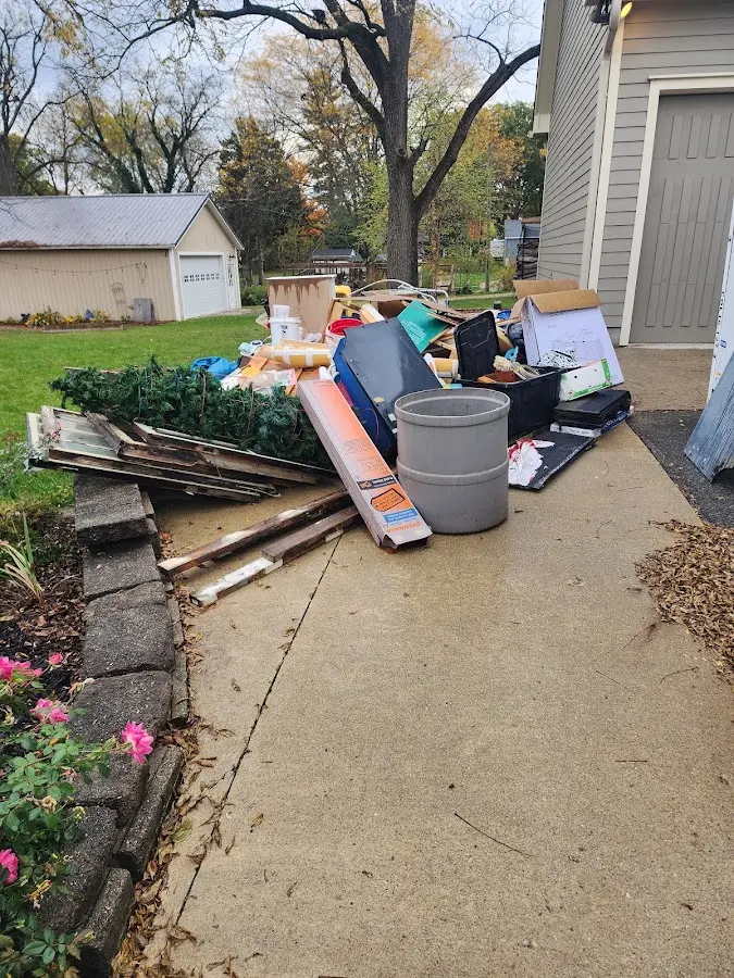 Dumpster being loaded with debris for 3 Yard Dumpster Rental in Oconto